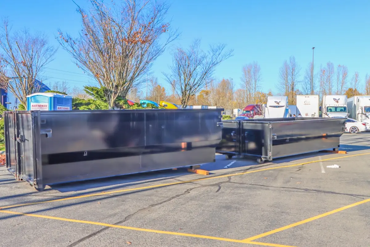 Professional dumpster rental service with roll-off container on residential driveway in Crescent City